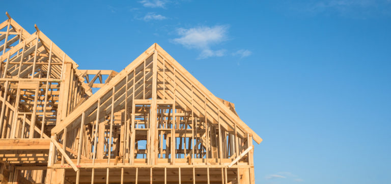 House frame against a bright blue sky